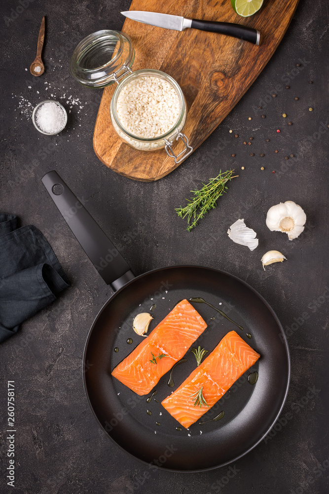 Salmon Steaks Fresh and Raw in Frying Pan with Thyme and Garlic