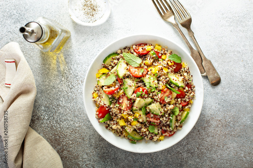 Fresh quinoa tabbouleh salad with tomatoes and cucumbers photo