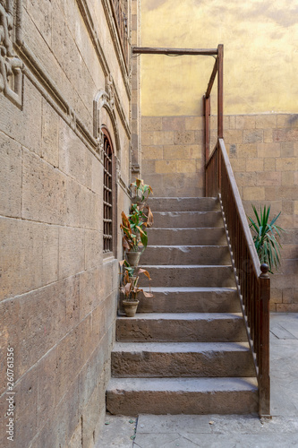 Old stone stair case with wooden balustrade leading to historic Beit Zeinab Khatoun building (Zeinab Khatoun House), Old Cairo, Egypt photo