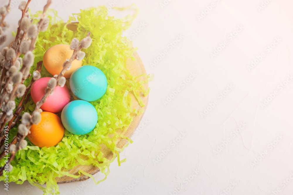 Easter eggs on the grass with willow branches