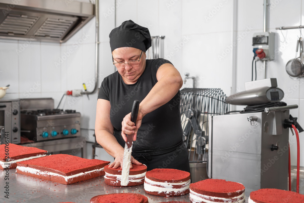Woman pastry chef smiling and working happy, making cakes at the pastry shop . Woman pastry chef smiling and working happy, making cakes at the pastry shop .