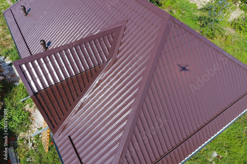 A view from above on the roof of the house. The roof of corrugated sheet. Roofing of metal profile wavy shape