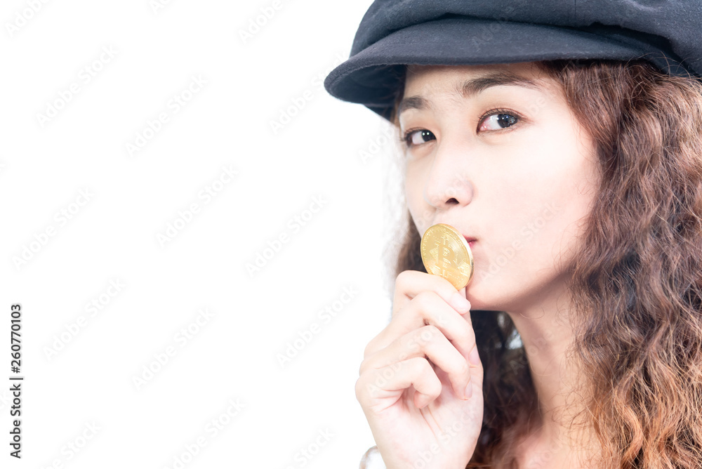 Young pretty girl kissing  golden bitcoin coin isolated on white background. Modern asian female biting gold bitcoin. Blockchain cashless finance business ,future digital money concept