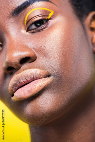 Cropped view of beautiful african american woman isolated on yellow