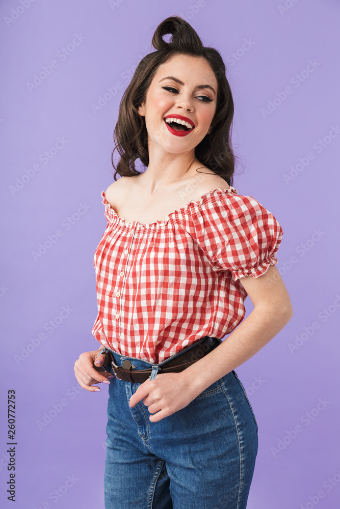 Portrait of happy pin-up woman 20s in american style wear smiling at camera Portrait of happy pin-up woman 20s in american style wear smiling at camera