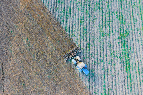 Top view of the tractor that plows the field. disking the soil. Soil cultivation after harvest photo