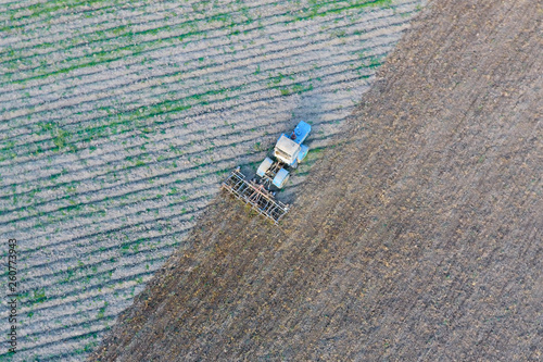 Top view of the tractor that plows the field. disking the soil. Soil cultivation after harvest photo