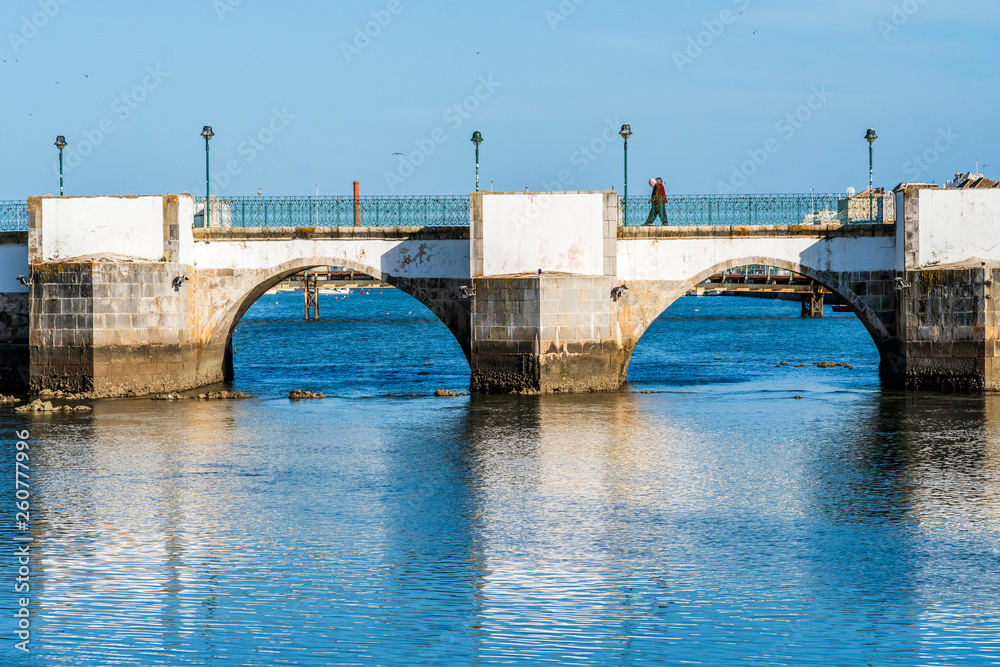 Old roman bridge over Gilao river in Tavira, Algarve, Portugal