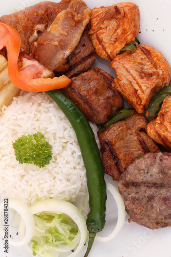 Close-Up of Mixed Grill Platter - Juicy Lamb & Chicken Kebab Skewers with Saffron Rice & Crispy Fries - Middle Eastern Feast