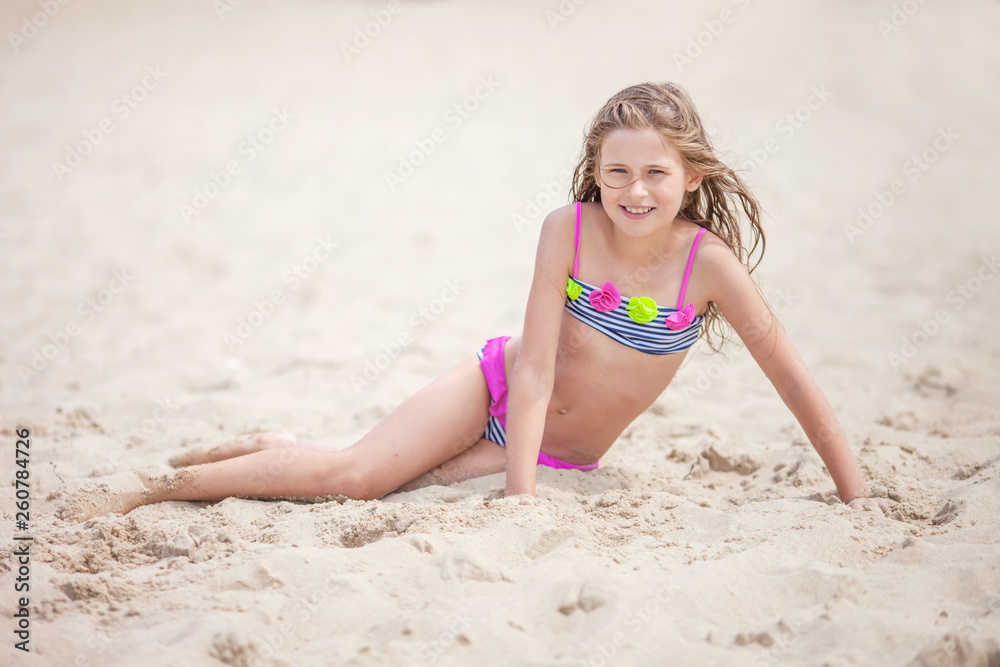 Beautiful young girl relaxing on the beach. Portrait of teen girl on sea  sand Stock Photo | Adobe Stock