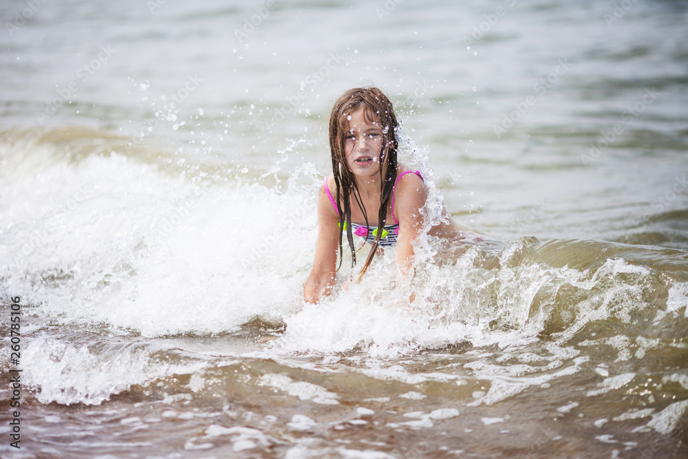Cute girl swiming in the sea. Little girl froze, she is dissatisfied, it is a lot of splashes Cute girl swiming in the sea. Little girl froze, she is dissatisfied, it is a lot of splashes
