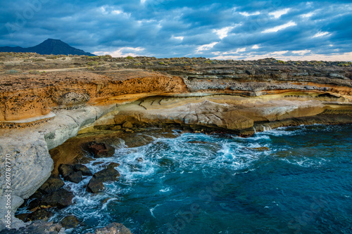 Cove at sunset with cloudscape and rocks