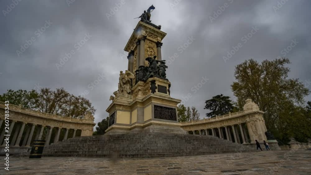 Bottom view slidincg camera timelapse of Alfonso XII monument under the rain in El Retiro, Madrid