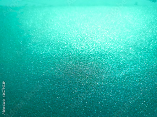 Abstract turquoise glitter bokeh background with copy space