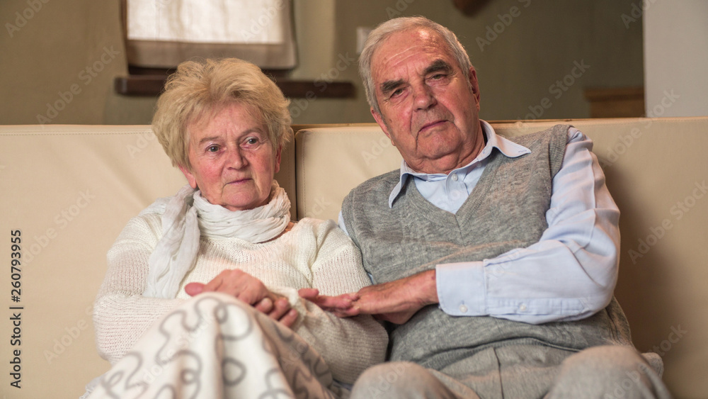 Portrait of very old grandparents on couch