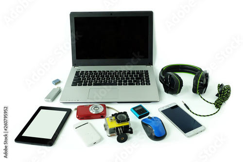 Desk with gadgets or electronic equipment for daily use, laptop computer, cell phones and digital camera isolated on white background