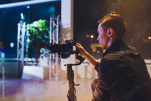 Photos Professional videographer holding camera on 3-axis gimbal