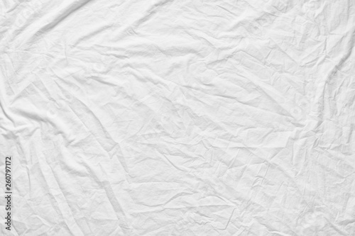 White fabic texture wrinkled texture ,Soft focus white fabic crumpled from bedding sheet use us background photo