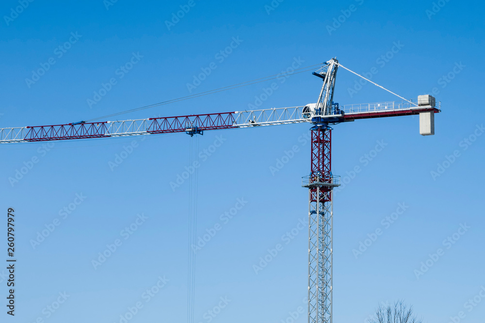 Multi-storey construction. Crane on the background of the blue sky. Copy space. Multi-storey construction. Crane on the background of the blue sky. Copy space.