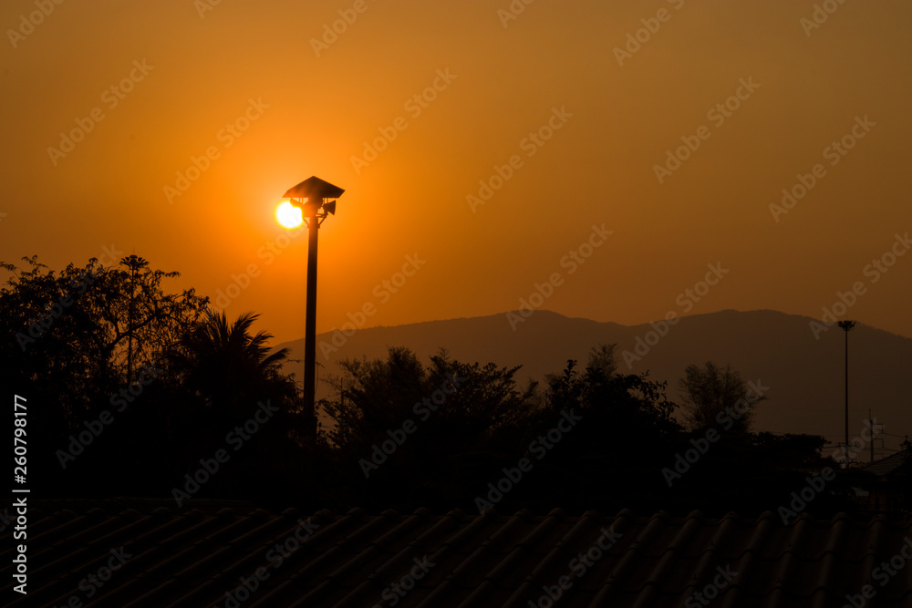 Sunset behind the sky, orange sky, unset at city of Chiangmai with building silhouette