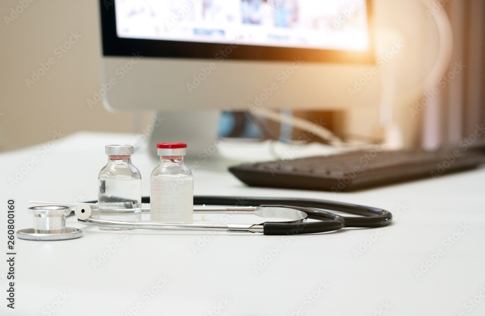 Headphones and medicine bottles placed on the table and the doctor printed a report on the desktop. Headphones and medicine bottles placed on the table and the doctor printed a report on the desktop.