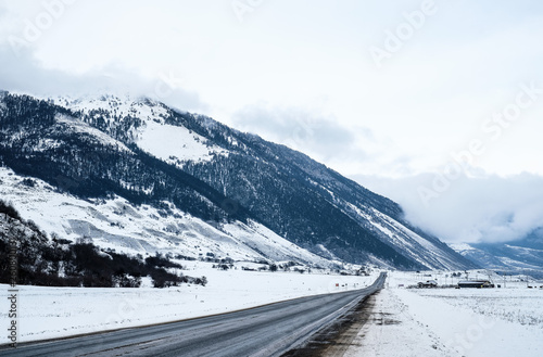The road in the snow-capped mountains . Winter landscape. 