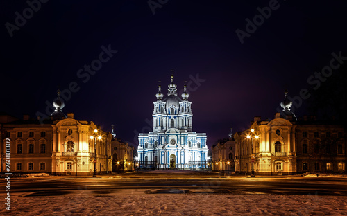 Smolny Cathedral in baroque style under lantern light. Rastrelli Square, Saint Petersburg, Russia. Cityscape in deep winter night.