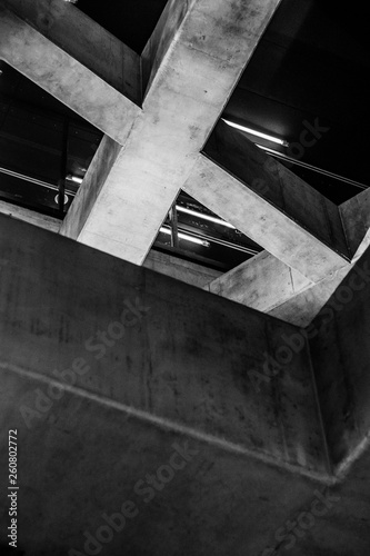 Black and white intersecting concrete beams at subway station