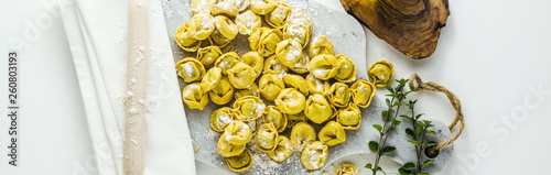 banner of raw ravioli tortellini on the table with flour and rolling pin. cooking healthy italian home cookingini on the table with flour and rolling pin. cooking healthy italian home cooking
