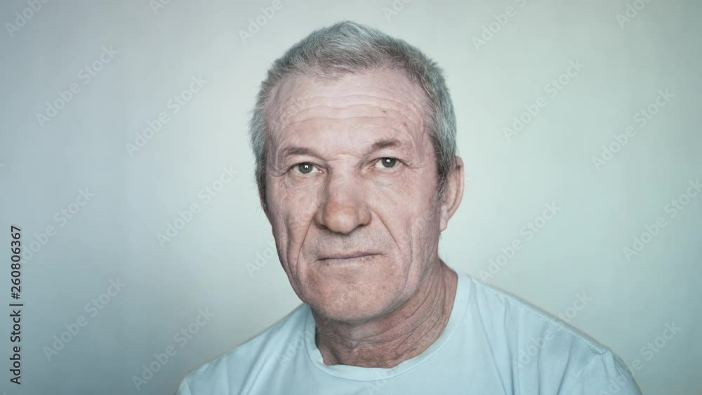 Close-up portrait of a brooding elderly man looking into the camera. Portrait of a smiling happy old man. Close-up of grandfather. Slow motion, 4K. Red epic. Close-up portrait of a brooding elderly man looking into the camera. Portrait of a smiling happy old man. Close-up of grandfather. Slow motion, 4K. Red epic.