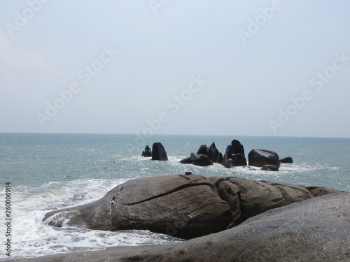 Blue beach with big rocks