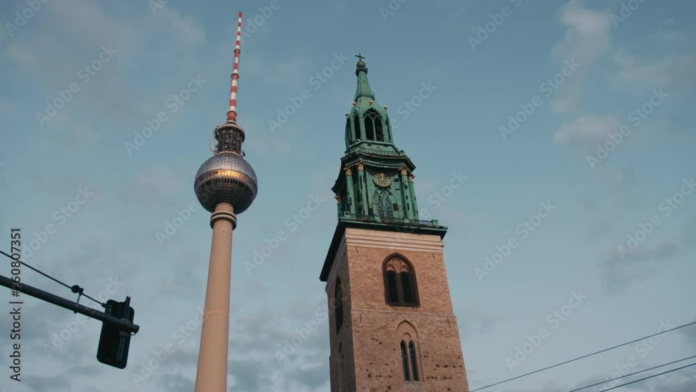 Symbols of Berlin, the clock and television tower on the background of the sky. Symbols of Berlin, the clock and television tower on the background of the sky.