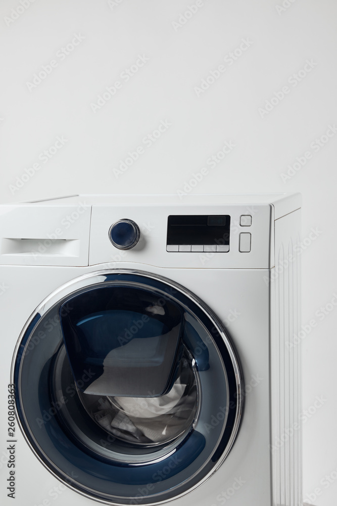 Modern washing machine with black display isolated on grey Modern washing machine with black display isolated on grey