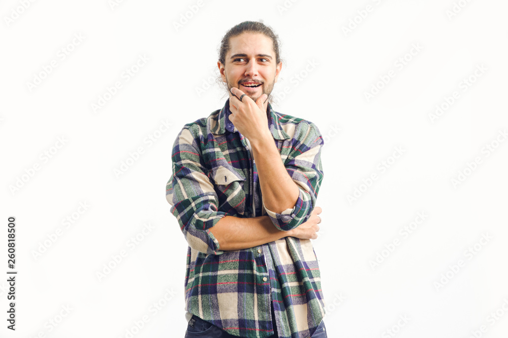 Young bearded surprised man standing on a light background. Cunning. Young bearded surprised man standing on a light background. Cunning.