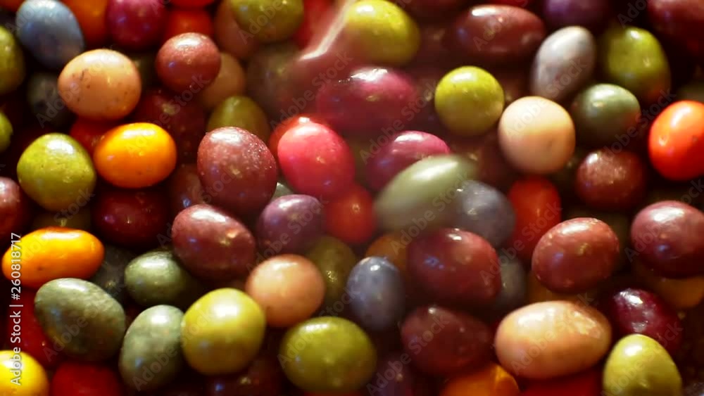 chocolates covered with colored glaze.close-up.moving sweets background. chocolates covered with colored glaze.close-up.moving sweets background.