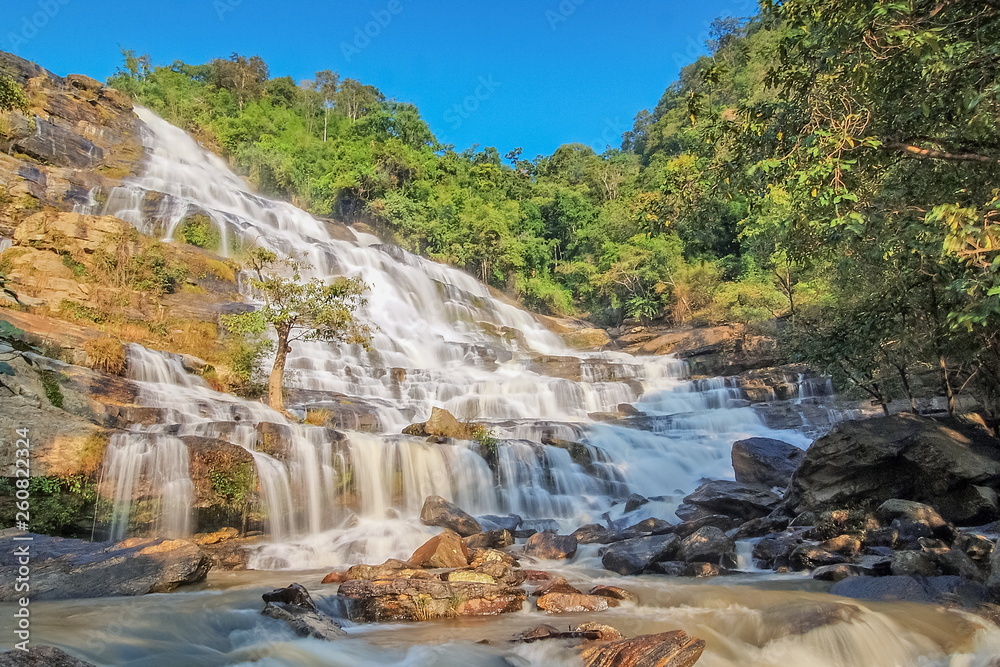 Mae Ya Waterfall, beautiful silky water flowing around with green forest and blue sky background, Chom Thong District, Chiang Mai, northern of Thailand. Mae Ya Waterfall, beautiful silky water flowing around with green forest and blue sky background, Chom Thong District, Chiang Mai, northern of Thailand.