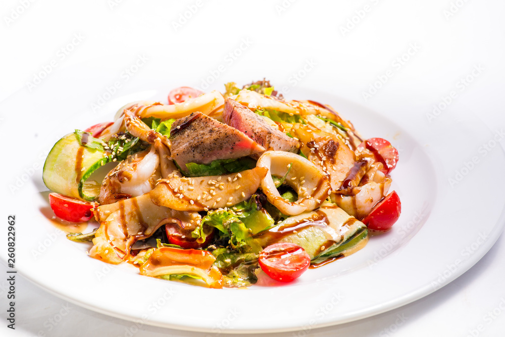 seafood salad with teriyaki sauce in a white plate seafood salad with teriyaki sauce in a white plate