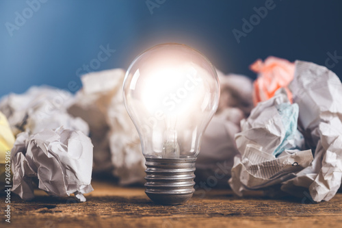 idea or light bulb with papers on the desk