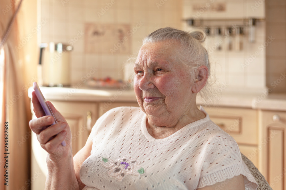 90 year old grandmother talking on a smartphone 90 year old grandmother talking on a smartphone