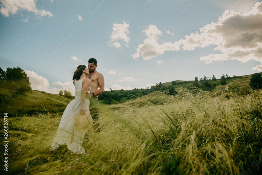 lifestyle . Man and a woman together outdoor. Kiss on the nature.