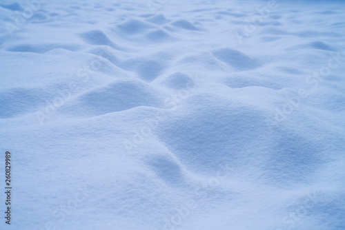 Fresh bumpy snow landscape in freezing blue tone for background.