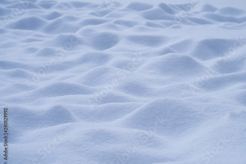 Fresh bumpy snow landscape in freezing blue tone for background.