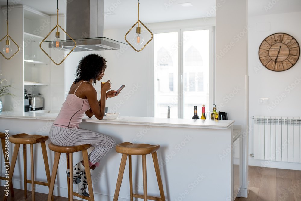 Woman having breakfast with mobile phone Woman having breakfast with mobile phone