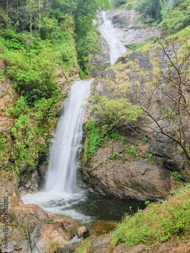Mae Pan Waterfall  view of silky water flowing from high cliff around with green forest background  Doi Inthanon  Chiang Mai  northern of Thailand.