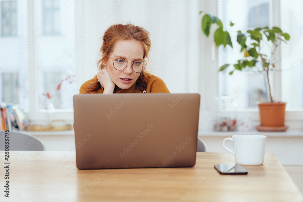 Serious worried young woman working on a laptop Serious worried young woman working on a laptop