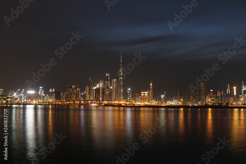 Night view of Dubai Skyline under Cloudy Sky, Dubai Downtown Residential and Business Skyscrapers, a view from Dubai Water Canal, Dubai, United Arab Emirates