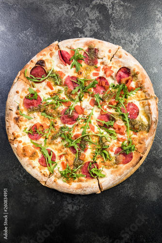 Pepperoni pizza with fresh arugula photo