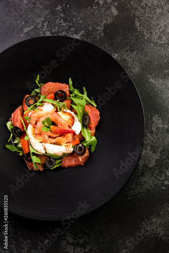 Fresh salad.Concept for a tasty and healthy meal. Dark stone background.