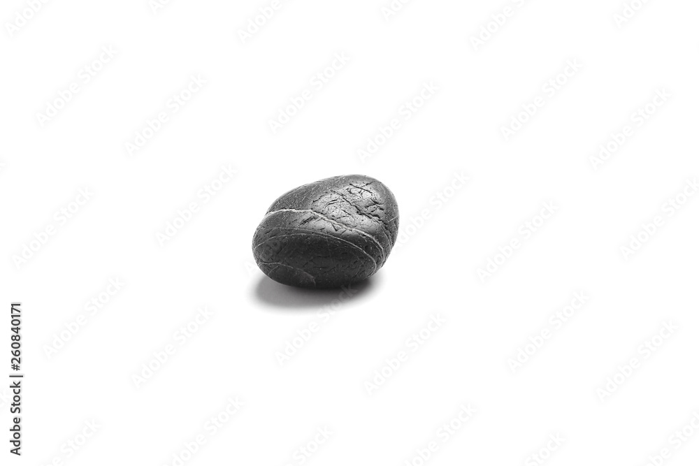 Fototapeta premium Single black pebble isolated on white background. Smooth sea stone