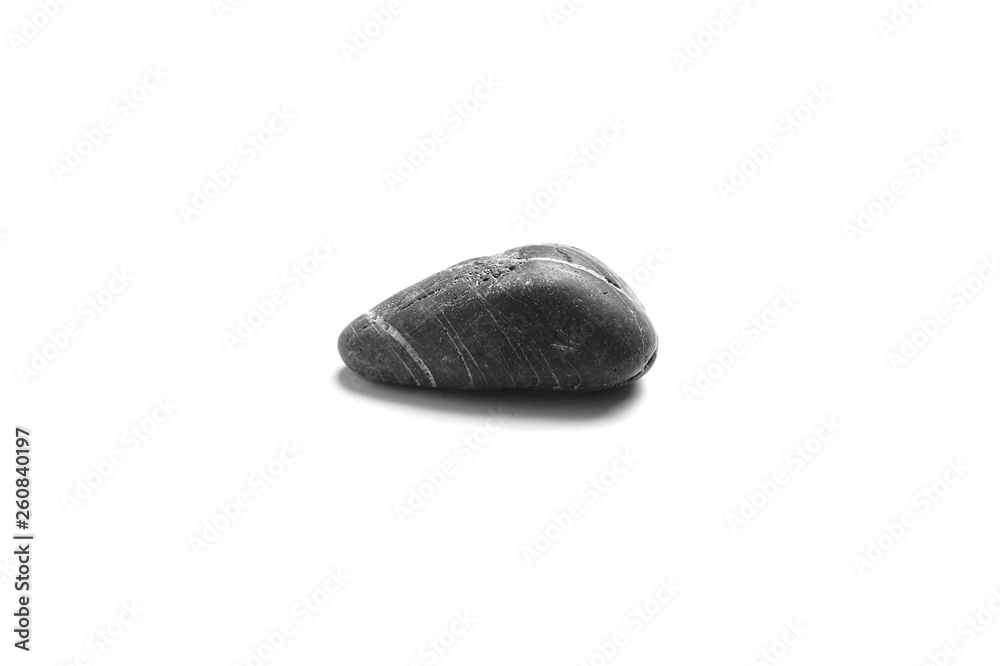 Fototapeta premium Single black pebble isolated on white background. Smooth sea stone